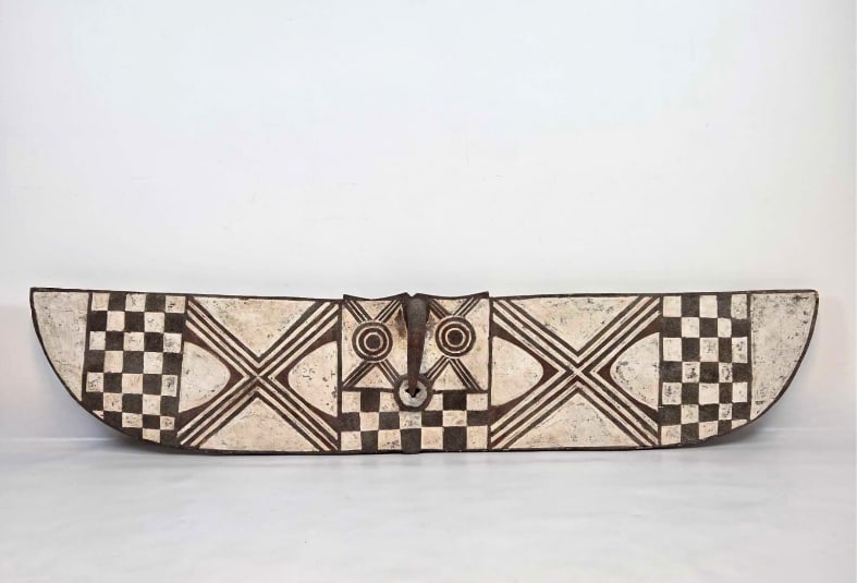 LARGE BURKINA FASO BWA TRIBAL HAWK PLANK MASK: Monumental hand-carved and pigment-painted African tribal spirit mask depicting a stylized hawk with outstretched wings decorated in geometric checkerboard and chevron patterns. Approximate Dimensions