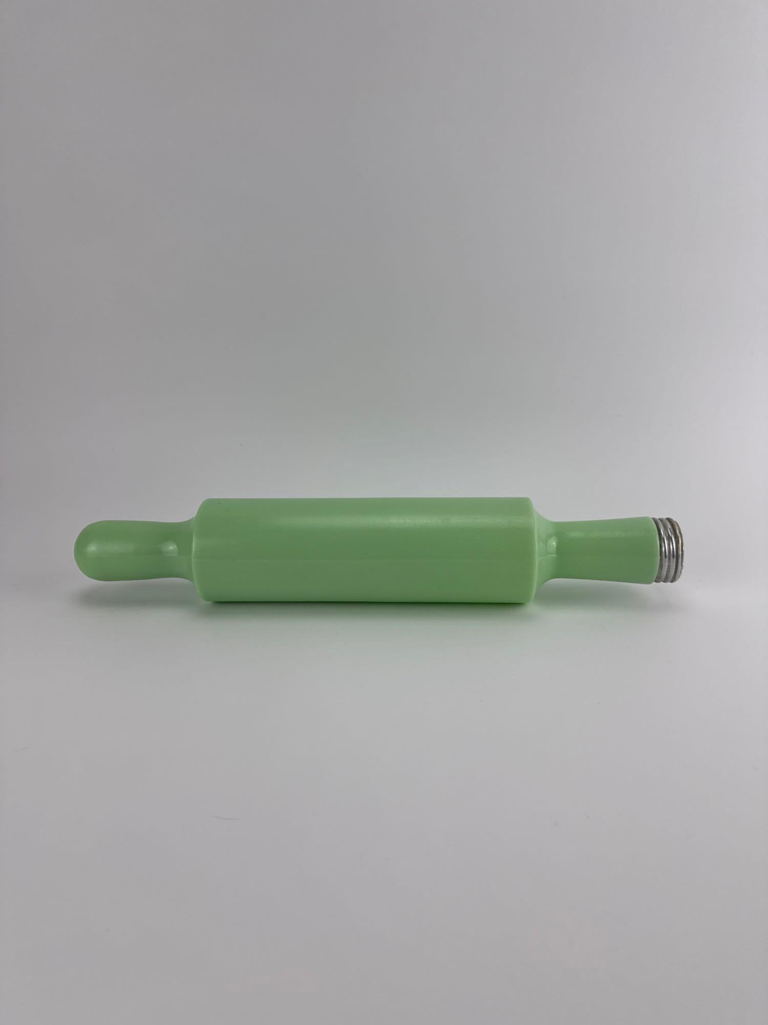 VINTAGE MCKEE GLASS CO. JADEITE HOLLOW GLASS ROLLING PIN WITH METAL CAP: Vintage 1930s opaque green uranium jadeite hollow glass pastry rolling pin complete with its original threaded metal end cap. Approximate Dimensions: 16” x 3”dia Artist or Maker: McKee