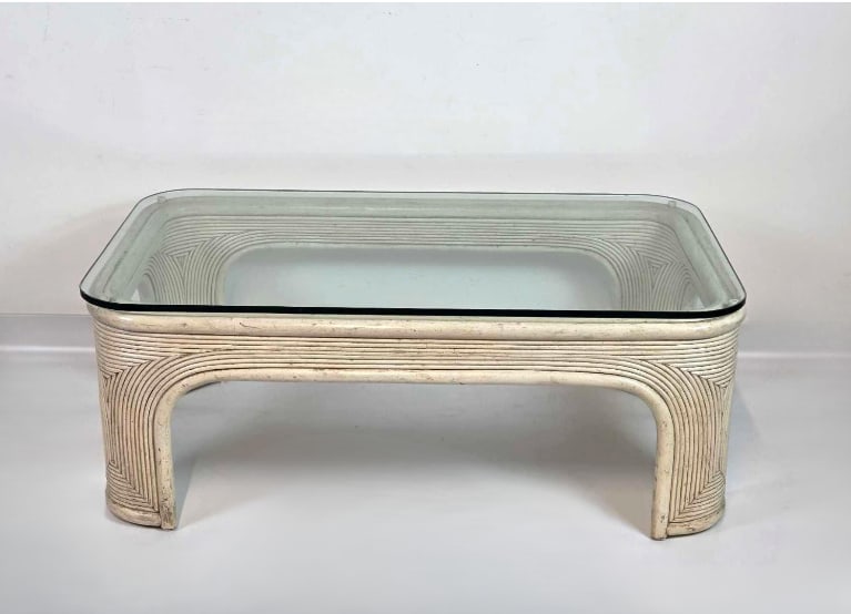 VINTAGE WHITE RATTAN GLASS TOP COFFEE TABLE: A vintage, rectangular pencil reed rattan coffee table with inset clear glass top. Approximate Dimensions: 16.25" H x 42" W x 24" D Artist or Maker: Unknown Provenance: A New York Collecto