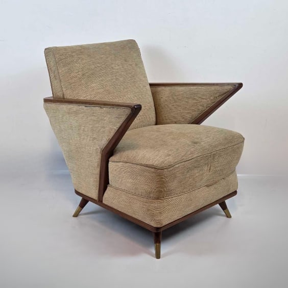 ITALIAN MID CENTURY CLUB CHAIR: Italian club chair with angled arms Italian mid-century modern club chair featuring dramatic angled wood-framed wing arms, upholstered in a tan textured fabric, resting on tapered wood legs with brass