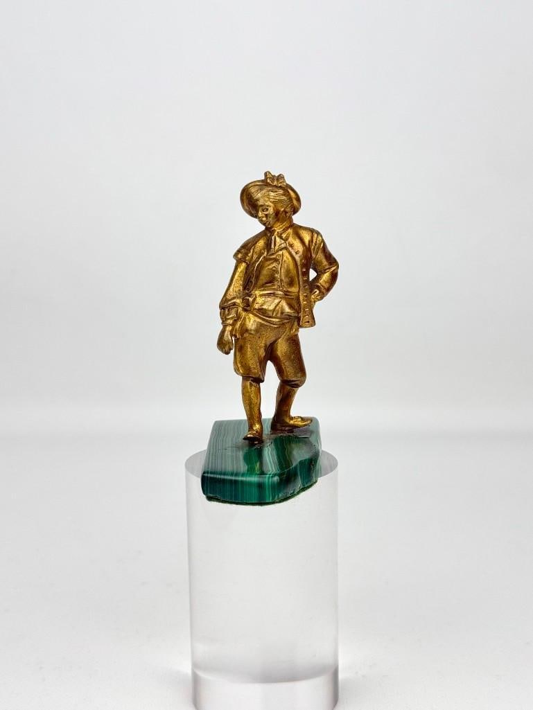 ANTIQUE RUSSIAN OR EUROPEAN GILT BRONZE BOY ON MALACHITE BASE: *Antique 19th-century or early 20th-century small cast bronze figural sculpture featuring a finely detailed young boy or page in traditional European court attire, finished in a bright gold d'ore 