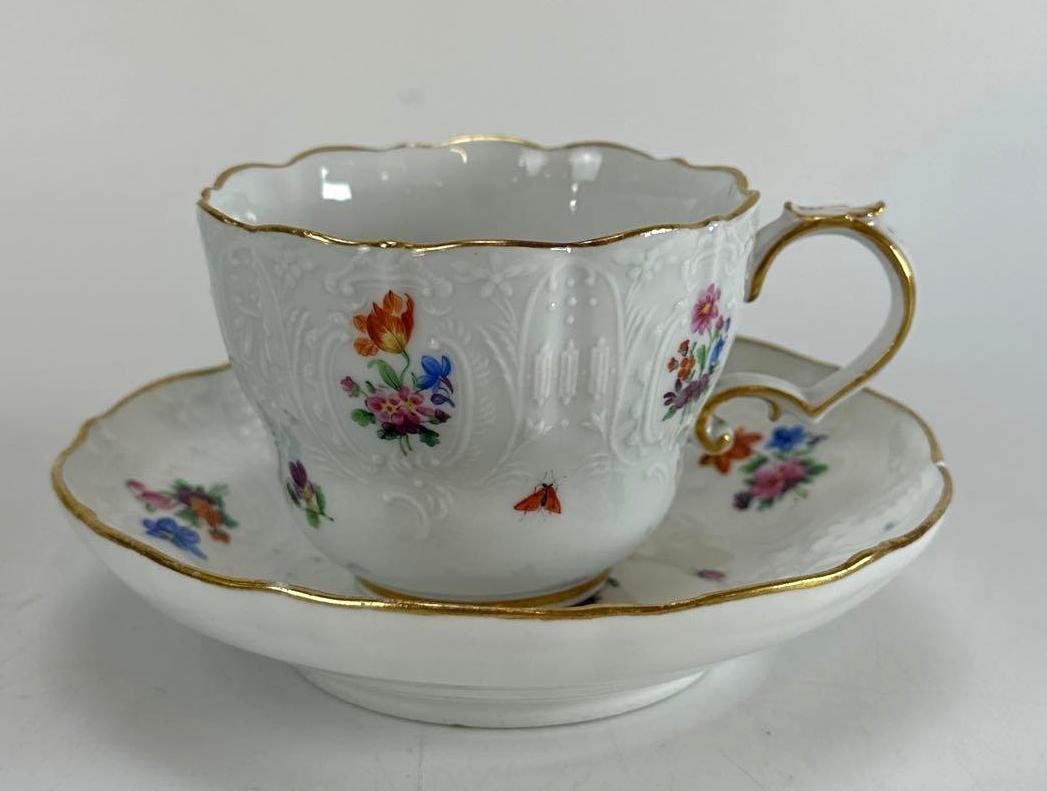 ANTIQUE MEISSEN HAND-PAINTED FLORAL TEACUP AND SAUCER: *Antique German Meissen hard-paste porcelain teacup and saucer Approximate Dimensions: 5.25”diameter x 3” Artist or Maker: Meissen Provenance: A New York Collector