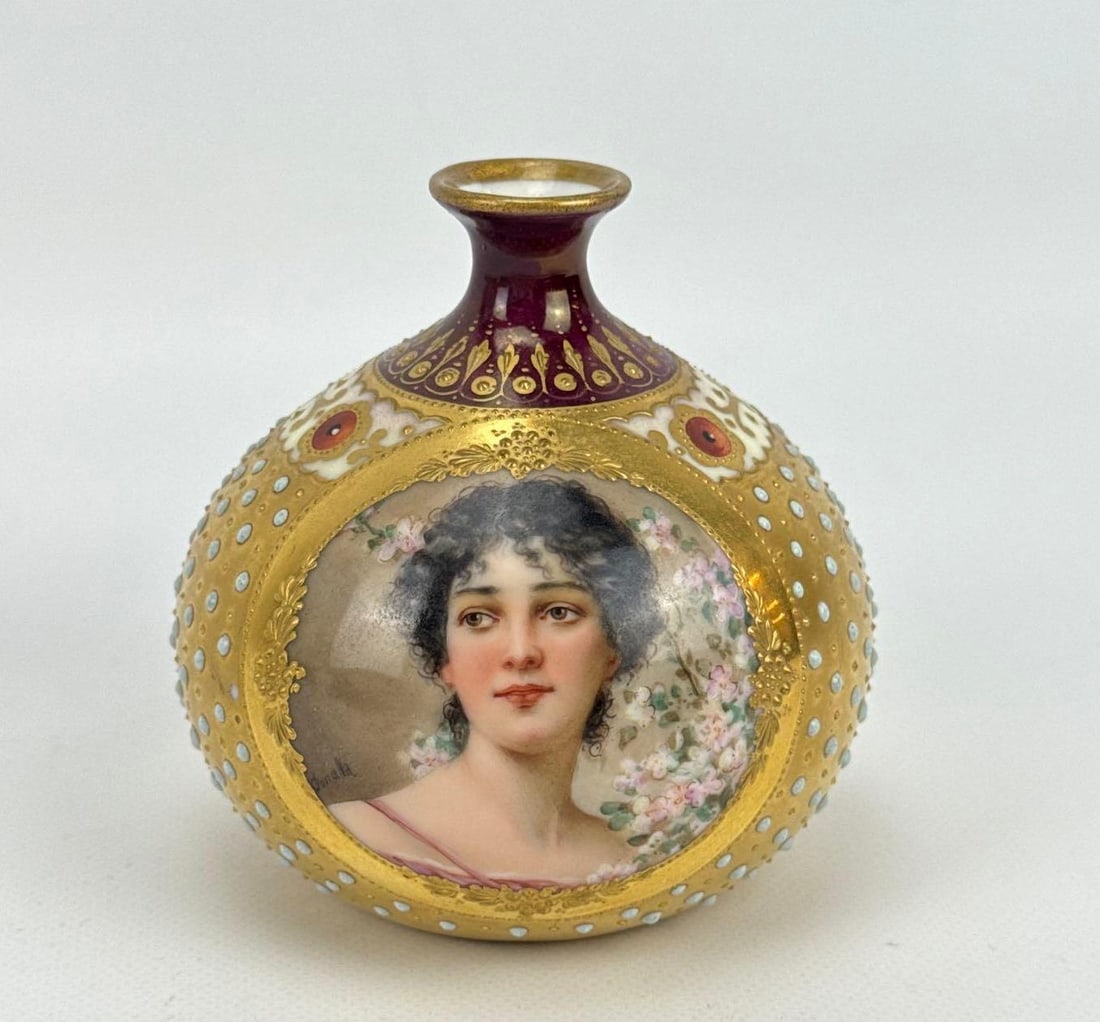 ANTIQUE ROYAL VIENNA PORTRAIT VASE: *Hand-painted miniature spherical gilt porcelain vessel depicting a young woman surrounded by apple blossoms. Marked Limoges France on bottom Approximate Dimensions: 3.5” H X 3.75” Dia Art