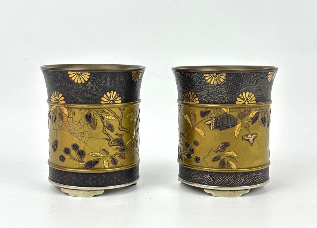 PAIR OF JAPANESE MEIJI PERIOD NOGAWA MARKED INLAID BRONZE BRUSH POTS: Exquisite pair of late 19th-century Japanese Meiji period patinated bronze cylindrical brush pots or bitong vessels by the Nogawa company showing intricate mixed metal gold and silver inlays. Approxim