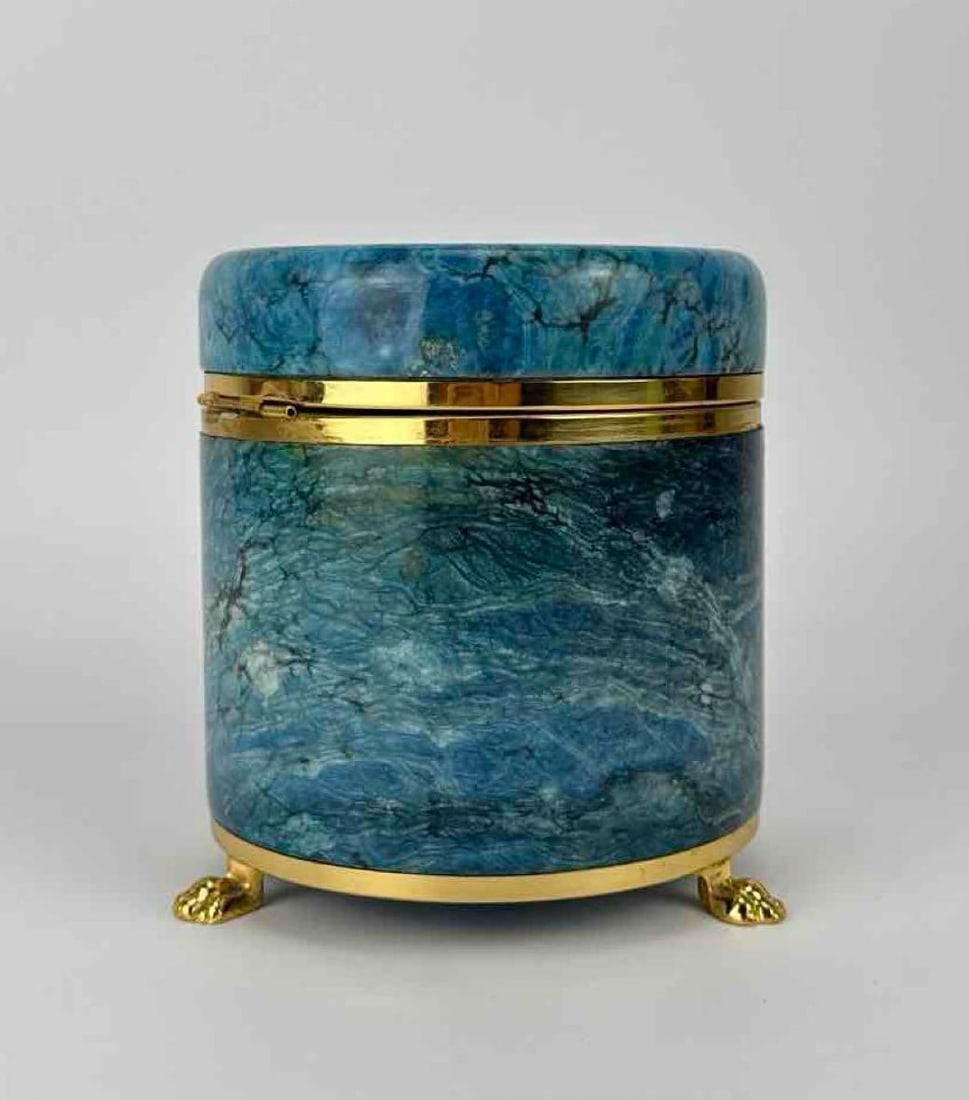 VINTAGE ITALIAN BLUE ALABASTER AND GILT METAL FOOTED TRINKET BOX: Hand-carved cylindrical blue marbled alabaster vessel with hinged lid and gilded brass claw feet. *Hinge is damaged and needs repair as seen in last photos Approximate Dimensions: 5.25” H X 5&rd