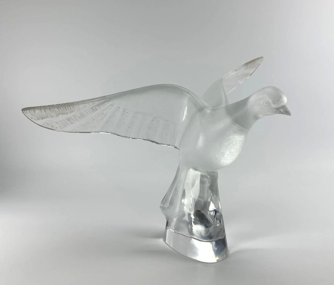LALIQUE FRANCE FROSTED CRYSTAL COLOMBE CLITA DOVE IN FLIGHT SCULPTURE: Large French frosted and polished clear crystal sculpture depicting a dove in flight with outstretched wings mounted on a pedestal base, signed to the side Approximate Dimensions: 9”x17”x1