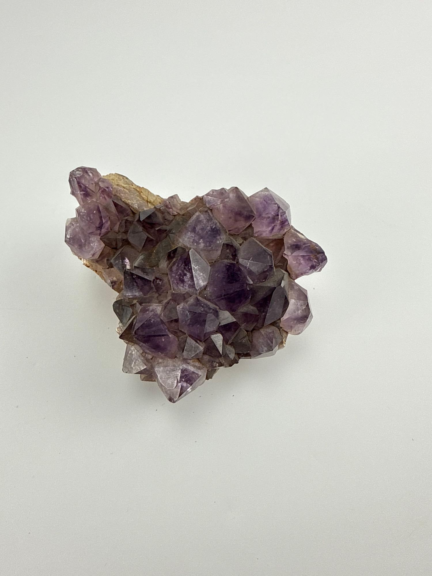 NATURAL URUGUAYAN DEEP PURPLE AMETHYST CRYSTAL CLUSTER SPECIMEN: Rough dark violet amethyst crystal points massed on a natural raw rock matrix base. Approximate Dimensions: 4" x 5" x 3" Artist or Maker: Unknown Provenance: A New Y