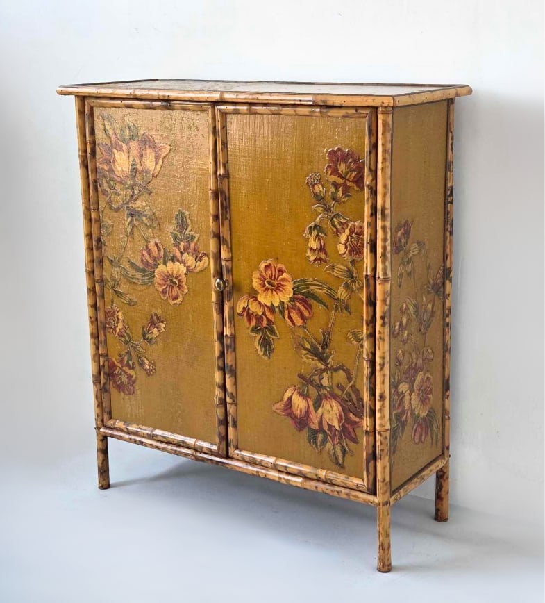 VINTAGE VICTORIAN STYLE TORTOISE BAMBOO AND FLORAL PAINTED TWO-DOOR CABINET: Vintage Victorian Aesthetic Movement style tortoise bamboo two-door cabinet featuring floral-lacquered front panels. Approximate Dimensions: 42" H X 37" W X 15" D Artist or Maker: Unknown