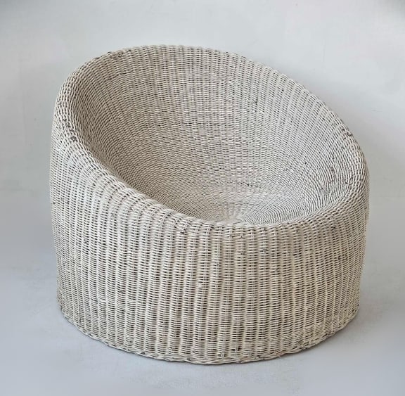 MID CENTURY WICKER AND BAMBOO ELEPHANT BOOT CHAIR IN THE STYLE OF EERO AARNIO: Mid-century modern round bucket accent chair crafted from woven wicker over a bamboo and rattan internal frame, designed in the iconic "Elephant Boot" style attributed to Eero Aarnio Approxima