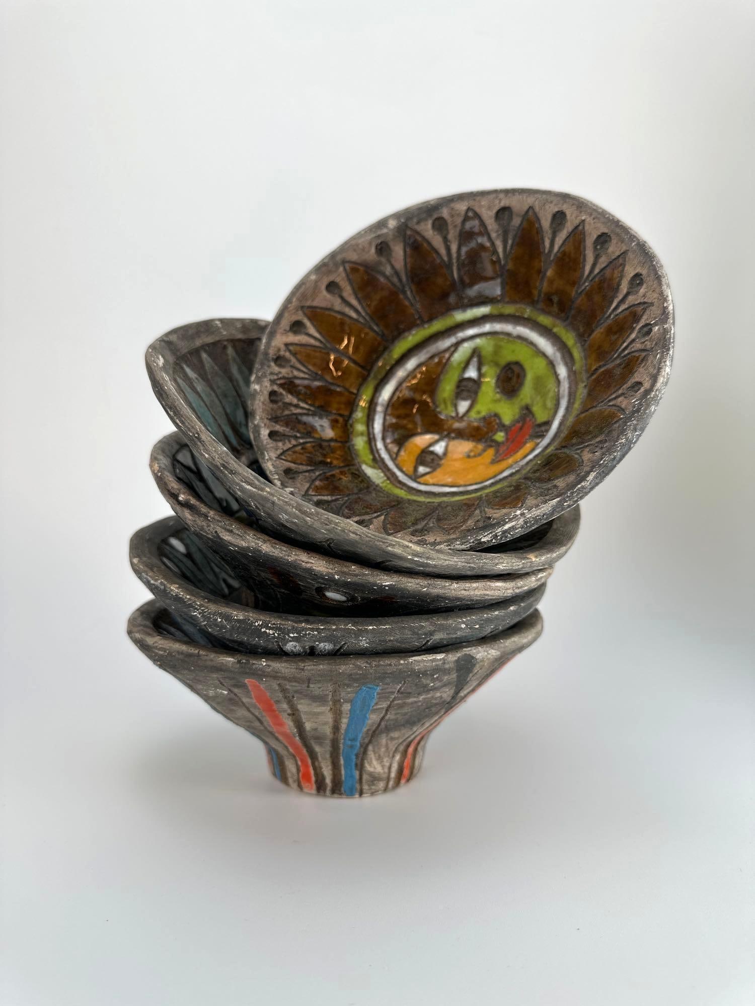 SET OF ALESSANDRA DOLO HAND-PAINTED CERAMIC BOWLS: Set of studio ceramic bowls with fluted rims and hand-painted stylized faces in polychrome glazes. Approximate Dimensions Largest Item: 3" H x 6.5" Dia. Artist or Maker: Alessandra Dolo Proven