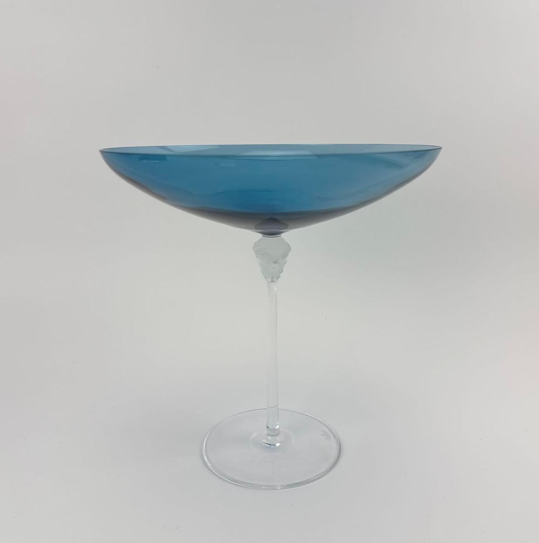 VERSACE ROSENTHAL MEDUSA-STEM SAPHIRE BLUE GLASS COMPOTE / CENTERPIECE: Footed compote with a shallow blue glass bowl on a frosted Medusa-head stem, signed. Approximate Dimensions: 8.5" H X 8" Dia. Artist or Maker: Versace for Rosenthal Provenance: From a New York