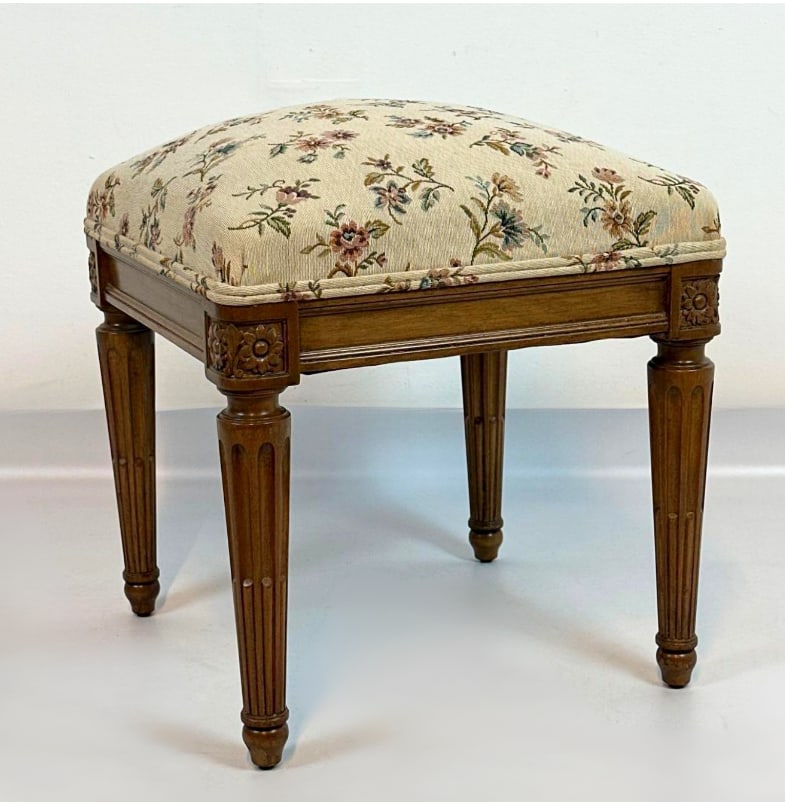 FRENCH LOUIS XVI STYLE FLORAL UPHOLSTERED VANITY STOOL: French Louis XVI style vanity stool with carved wood frame, fluted tapered legs with floral paterae, floral tapestry-style upholstered seat Approximate Dimensions: 18" H x 16" W x 16" D Ar