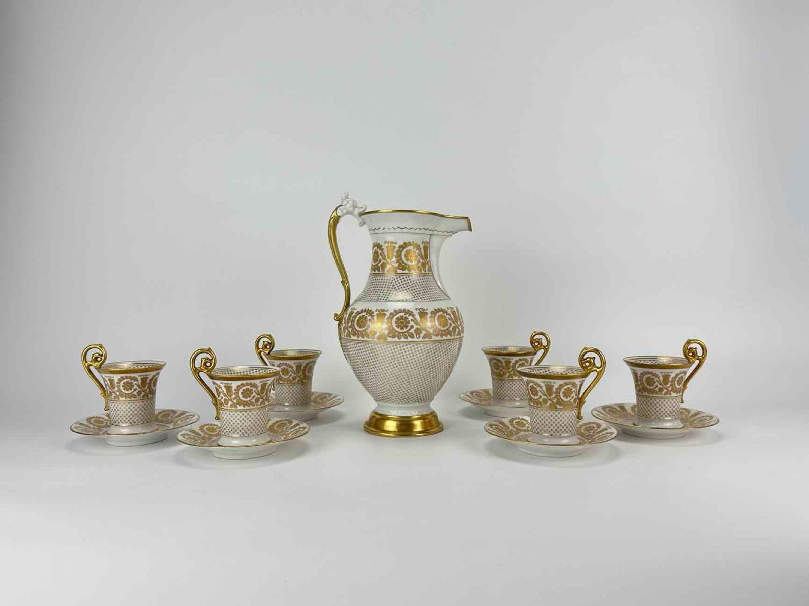 13-PIECE GILT T&V LIMOGES PORCELAIN TEA SET: Thirteen-piece gilt-decorated porcelain tea set with tall pot, cups and saucers, cream ground with gilt bands Approximate Dimensions Largest Item: 10.5" H x 7.5" W x 5.5" D (pot) Artist or