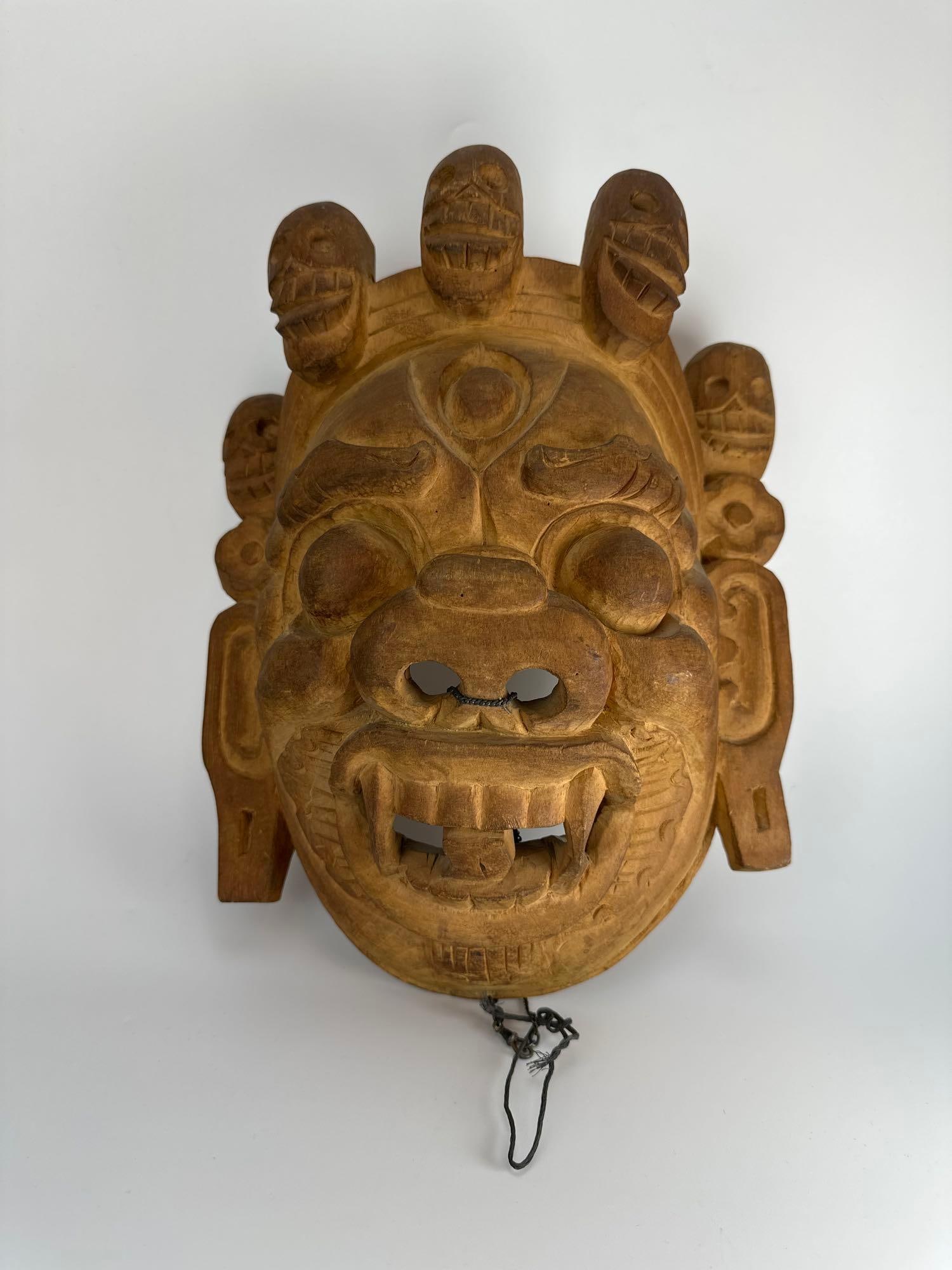 ANTIQUE TIBETAN CARVED WOOD MAHAKALA FESTIVAL MASK: Carved hardwood Himalayan festival mask of the wrathful deity Mahakala with skull crown, fangs and bulging eyes Approximate Dimensions: 14" H x 10" W x 7" D Artist or Maker: Unknown Proven