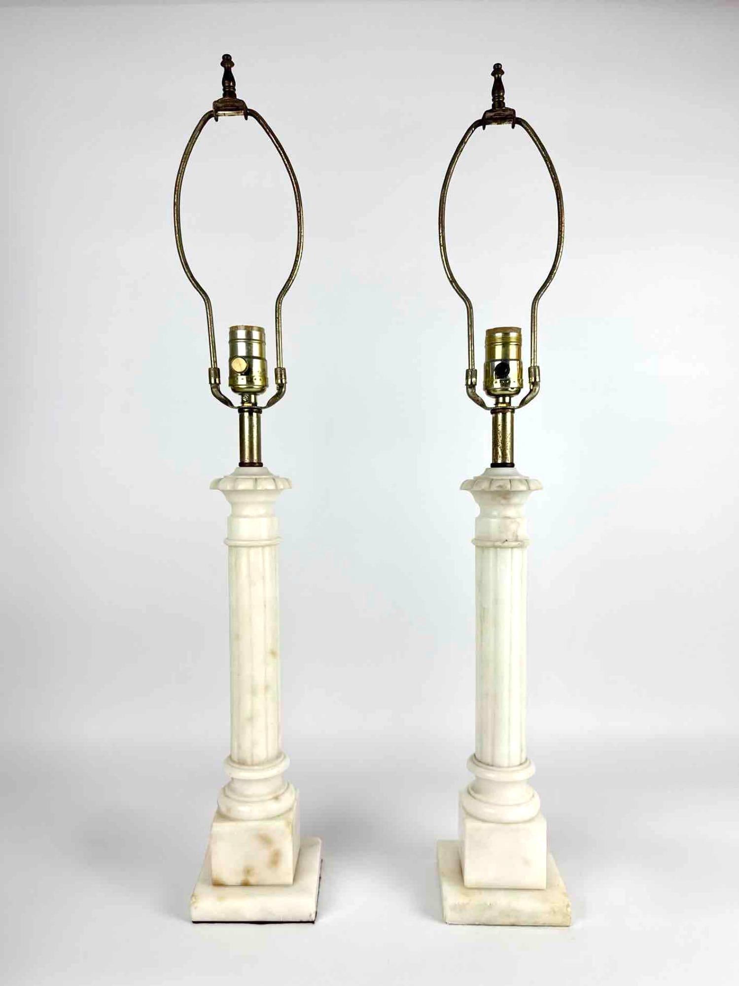 PAIR VINTAGE CARVED ALABASTER COLUMN TABLE LAMPS: Pair of carved alabaster fluted column table lamps on square stepped bases Approximate Dimensions: 20" H (29" H to top of harp) x 4.25" W x 4.25" D each Artist or Maker: Unknown Proven