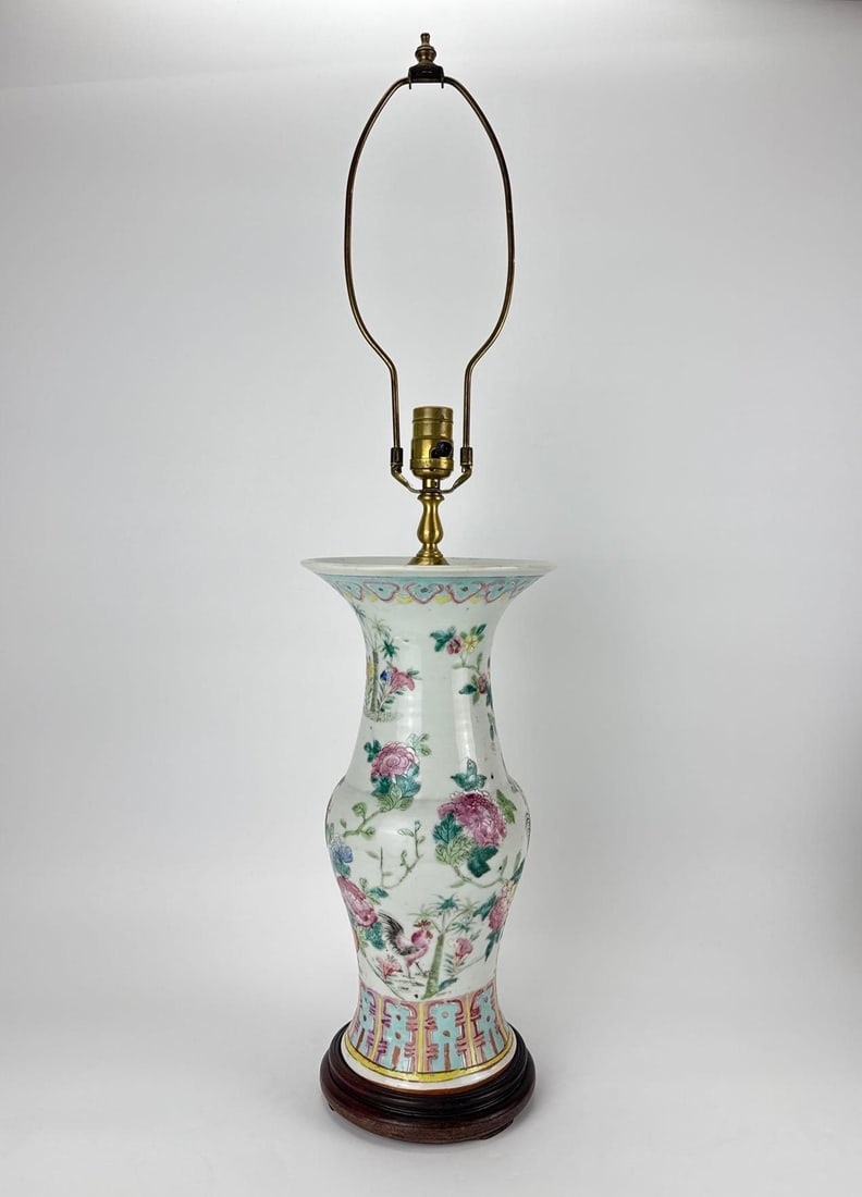 CHINESE FAMILLE ROSE BALUSTER VASE TABLE LAMP: Famille rose porcelain baluster vase mounted as a table lamp with bird-and-flower decoration on a carved wood base. Approximate Dimensions: 21.5" H X 8.5" Dia. Artist or Maker: Unknown Provena