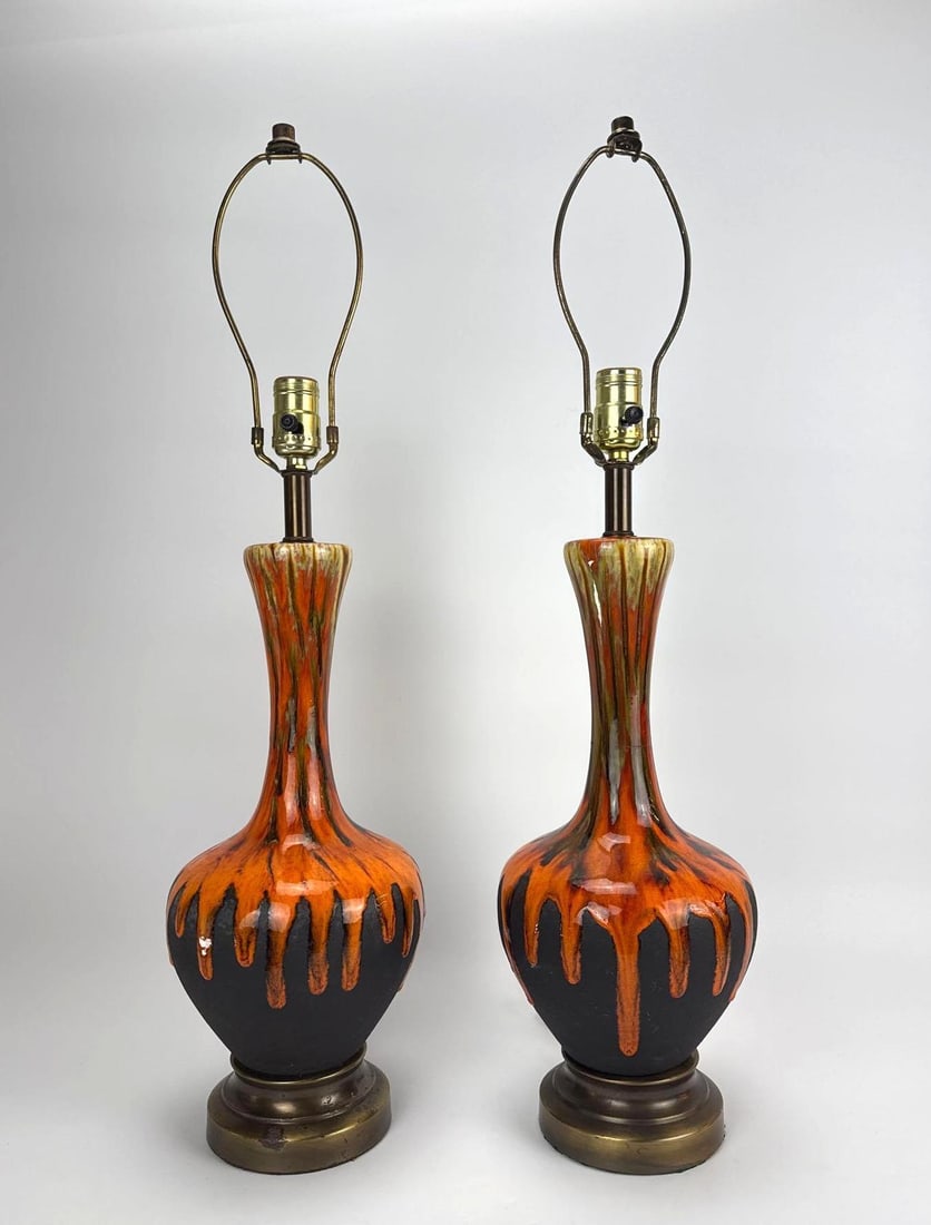 PAIR OF MIDCENTURY ORANGE "LAVA" DRIP-GLAZE LONG-NECK TABLE LAMPS: Pair of long-neck ceramic table lamps in orange-and-brown "lava" drip glaze on brass-tone bases. Approximate Dimensions: 21" H X 7" Dia.; 28" H to top of harp. Artist or Maker: Unk