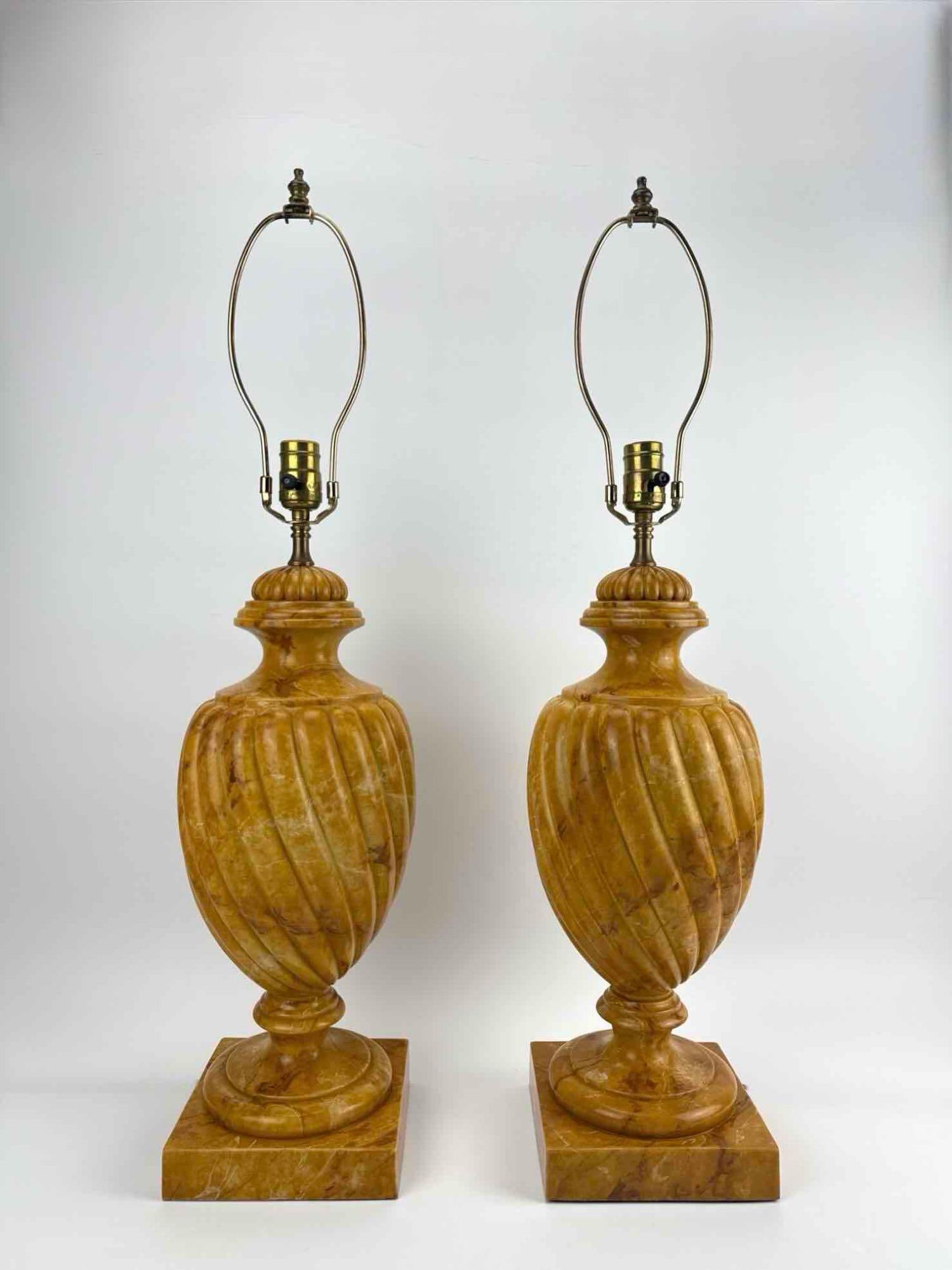 PAIR OF ACANTO CARVED MARBLE URN-FORM TABLE LAMPS SPAIN: Pair of carved stone urn-form table lamps with fluted baluster bodies on square plinths. Approximate Dimensions: 23" H X 8" Dia.; 31" H to top of harp. Artist or Maker: Acanto Provenance: 