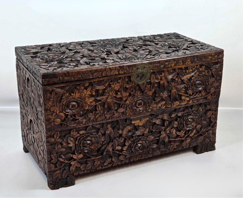 HEAVILY CARVED CHINESE CAMPHOR WOOD CHEST: Chinese camphor wood chest deeply carved on all sides with dragons, birds, and foliage, hinged lid. Approximate Dimensions: 19" H X 31.5" W X 15.25" D Artist or Maker: Unknown Provenance: 
