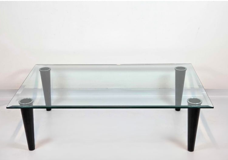VINTAGE RECTANGULAR BEVELED GLASS TOP COFFEE TABLE ON TAPERED METAL LEGS: Vintage rectangular coffee table with thick beveled glass top on black tapered metal legs Approximate Dimensions: 15" H x 51" W x 31.5" D Artist or Maker: Unknown Provenance: From a New Yo