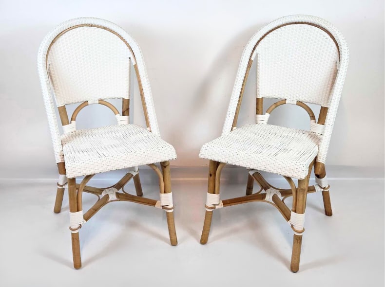 PAIR BENT RATTAN AND WOVEN NYLON FRENCH BISTRO CHAIRS: Pair of bent rattan French bistro style side chairs with white woven nylon seats and backs, maker label on frame Approximate Dimensions: 35.25" H x 18" W x 22" D each Artist or Maker: Outl