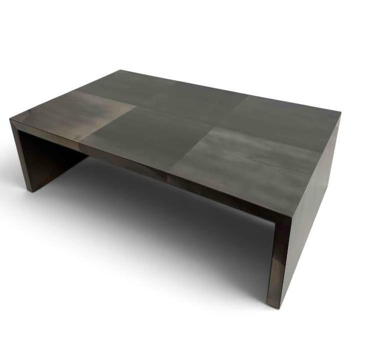 OLY STUDIO METAL-CLAD WATERFALL COFFEE TABLE RETAILS $3500: Modern waterfall coffee table with a burnished metal-clad finish, by Oly. Approximate Dimensions: 54.5" W X 33" D X 17" H Artist or Maker: Oly (Oly Studio) — brass maker's label Prov