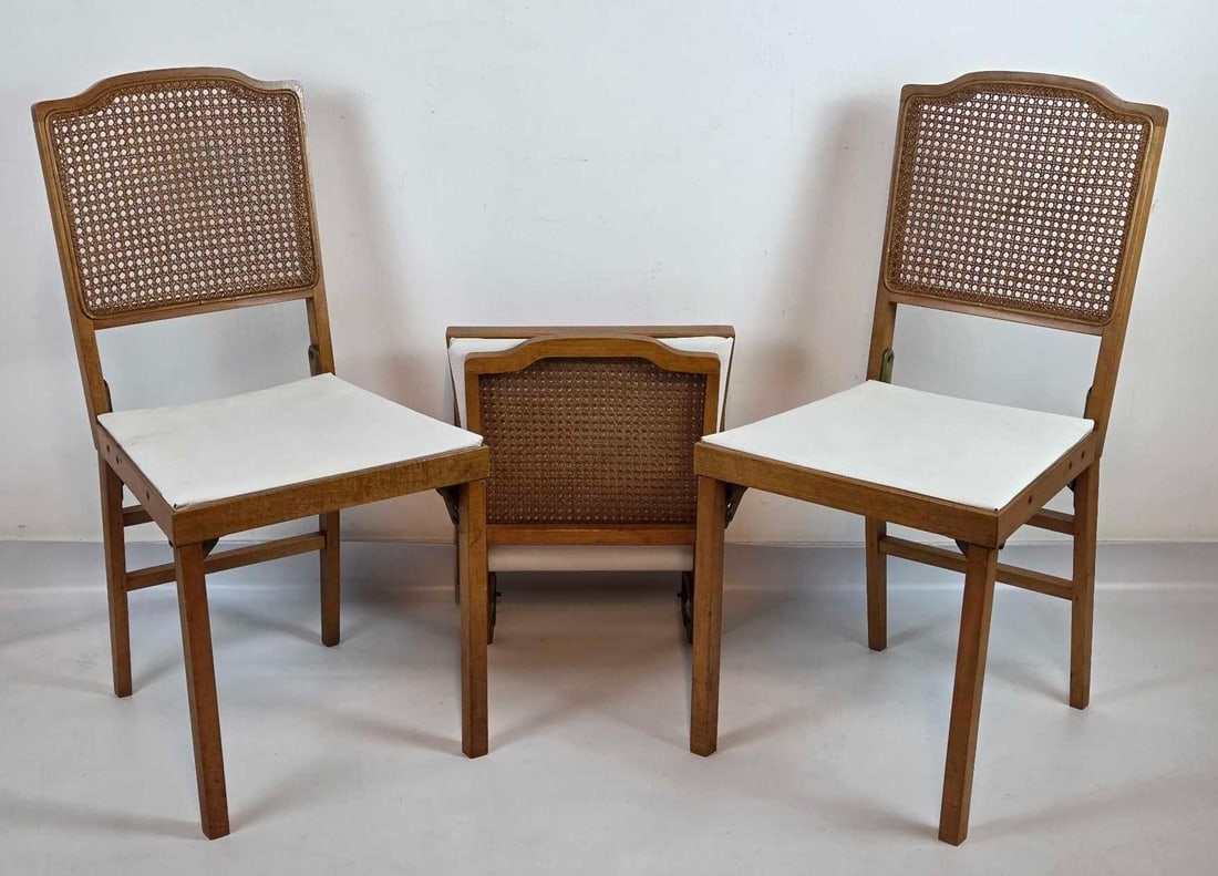 GROUP OF THREE LEG-O-MATIC AUTO FOLDING CHAIRS WITH CANE BACKS: Three Leg-O-Matic automatic folding chairs with wood frames, cane backs and upholstered seats, original labels Approximate Dimensions: 34.25" H x 17" W x 19" D open; 19" H x 17" W 