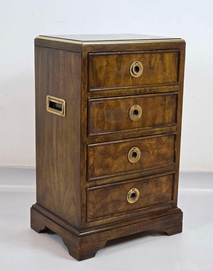 DREXEL CAMPAIGN STYLE BURLED WOOD DIMINUTIVE CHEST SIDE TABLE: Drexel campaign style diminutive chest of drawers with burled wood veneer, brass ring pulls and brass corner mounts Approximate Dimensions: 23.75" H x 15" W x 11.25" D Artist or Maker: Dre