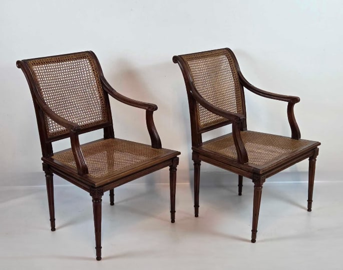 PAIR OF ANTIQUE LOUIS XVI STYLE CANED FAUTEUILS: *Pair of Louis XVI style armchairs (fauteuils) with caned backs and seats, carved wood frames, scrolled arms, and fluted tapered legs with carved rosette corner blocks. Approximate Dimensions: 35"