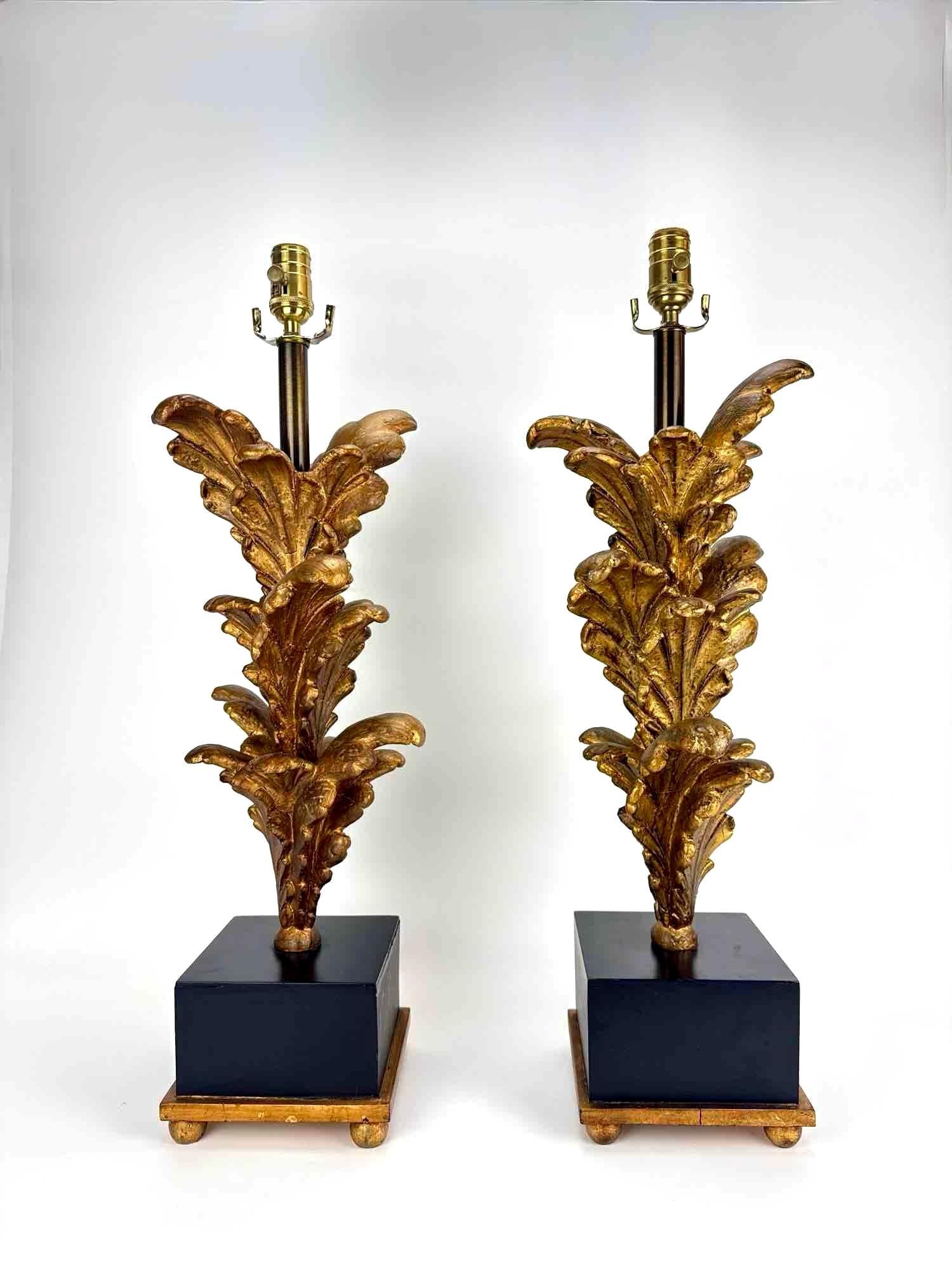 PAIR OF SUBSTANTIAL ITALIAN GILTWOOD ACANTHUS LEAF TABLE LAMPS 29": Pair of carved giltwood acanthus-leaf table lamps on black lacquer plinth bases. Approximate Dimensions: 28.5" H X 9" W X 7.5" D Artist or Maker: Unknown Provenance: From a New York Collec
