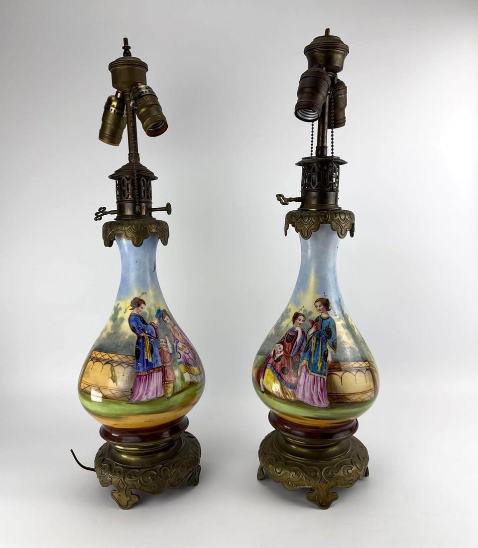 PAIR VINTAGE FRENCH CHINOISERIE HAND PAINTED PORCELAIN CONVERTED OIL LAMPS: *Pair of 19th-century French Chinoiserie hand-painted porcelain oil lamps decorated with Asian figures, converted to electric table lamps on pierced cast brass bases. Approximate Dimensions: 7” 