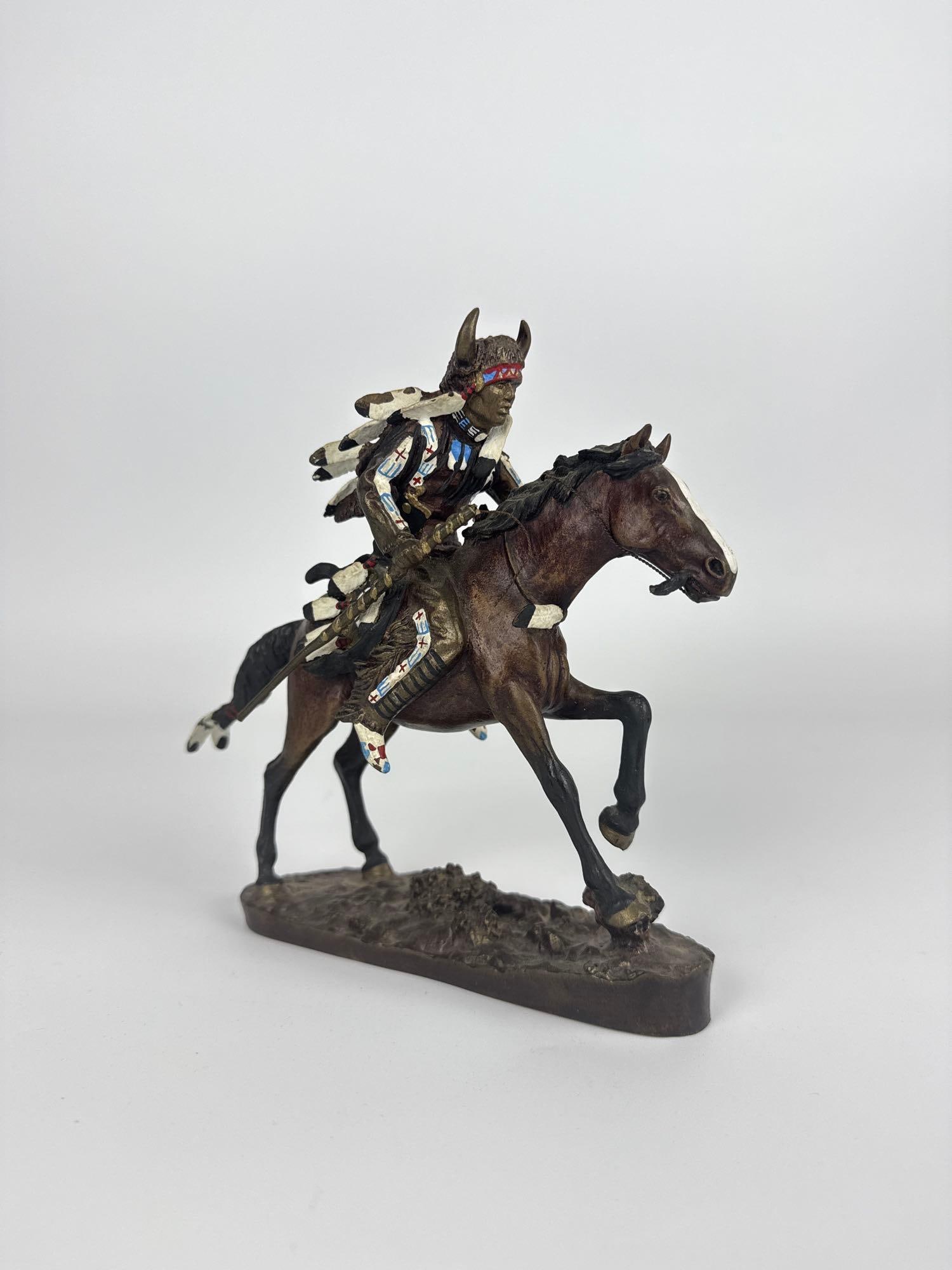 HAMILTON COLLECTION NOBLE WARRIORS BRONZE SCULPTURE AFTER CHUCK REN: *Cold-cast polychrome bronze sculpture depicting a Native American warrior mounted on a painted horse, designed by artist Chuck Ren for The Hamilton Collection. Approximate Dimensions: 6.5” “ 