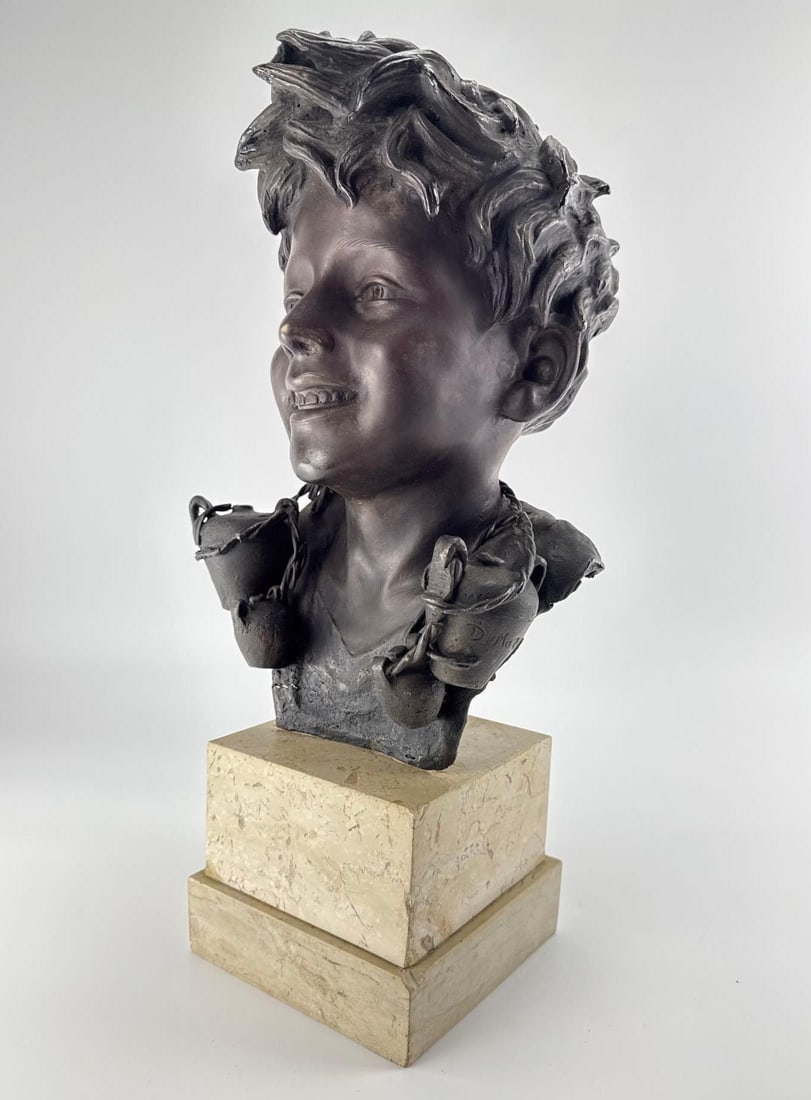 GIOVANNI DE MARTINO BRONZE BUST OF A NEAPOLITAN BOY ON MARBLE BASE: *Patinated bronze bust depicting a smiling young Neapolitan fisherman mounted on a tiered marble pedestal base. Approximate Dimensions: 8” x 8” x 17” H Artist or Maker: De Martino</