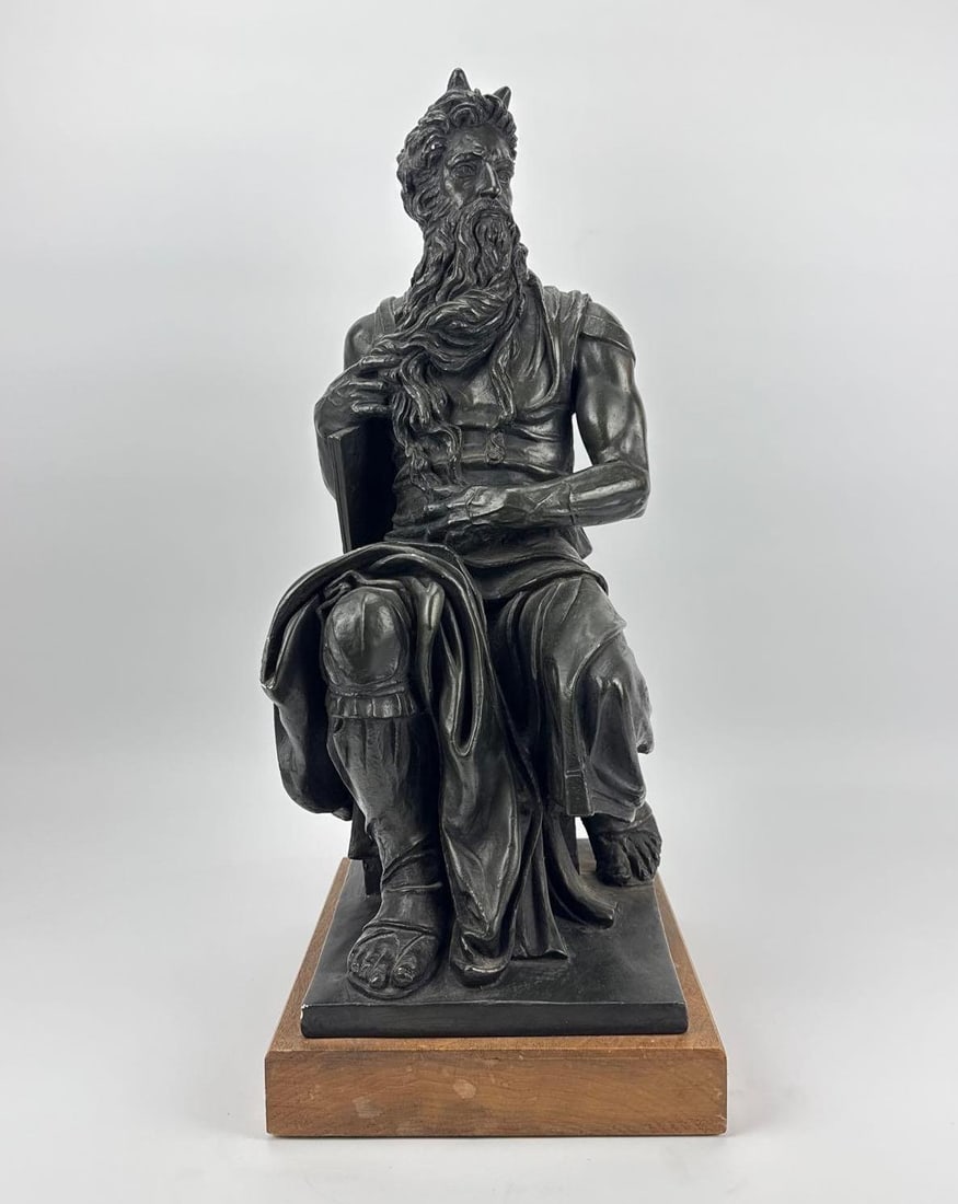 AUSTIN PRODUCTIONS MICHELANGELO MOSES DURASTONE STATUE ON WOOD BASE: *23-inch classical Durastone sculpture with bronze patina depicting Moses after Michelangelo mounted on a rectangular wooden base Approximate Dimensions: 23” H X 9” W X 10.75” D Arti