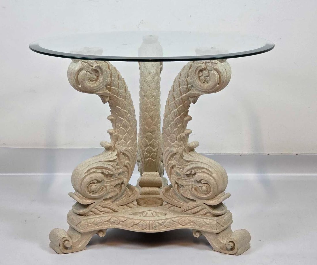 VINTAGE DOLPHIN FIGURAL GLASS TOP FAUX STONE OCCASIONAL TABLE: *Sculptural occasional table featuring a pair of carved dolphin figures in a faux stone finish, supporting a round glass top. Approximate Dimensions: 21.5"H x 26" Diameter Artist or Maker: Unk