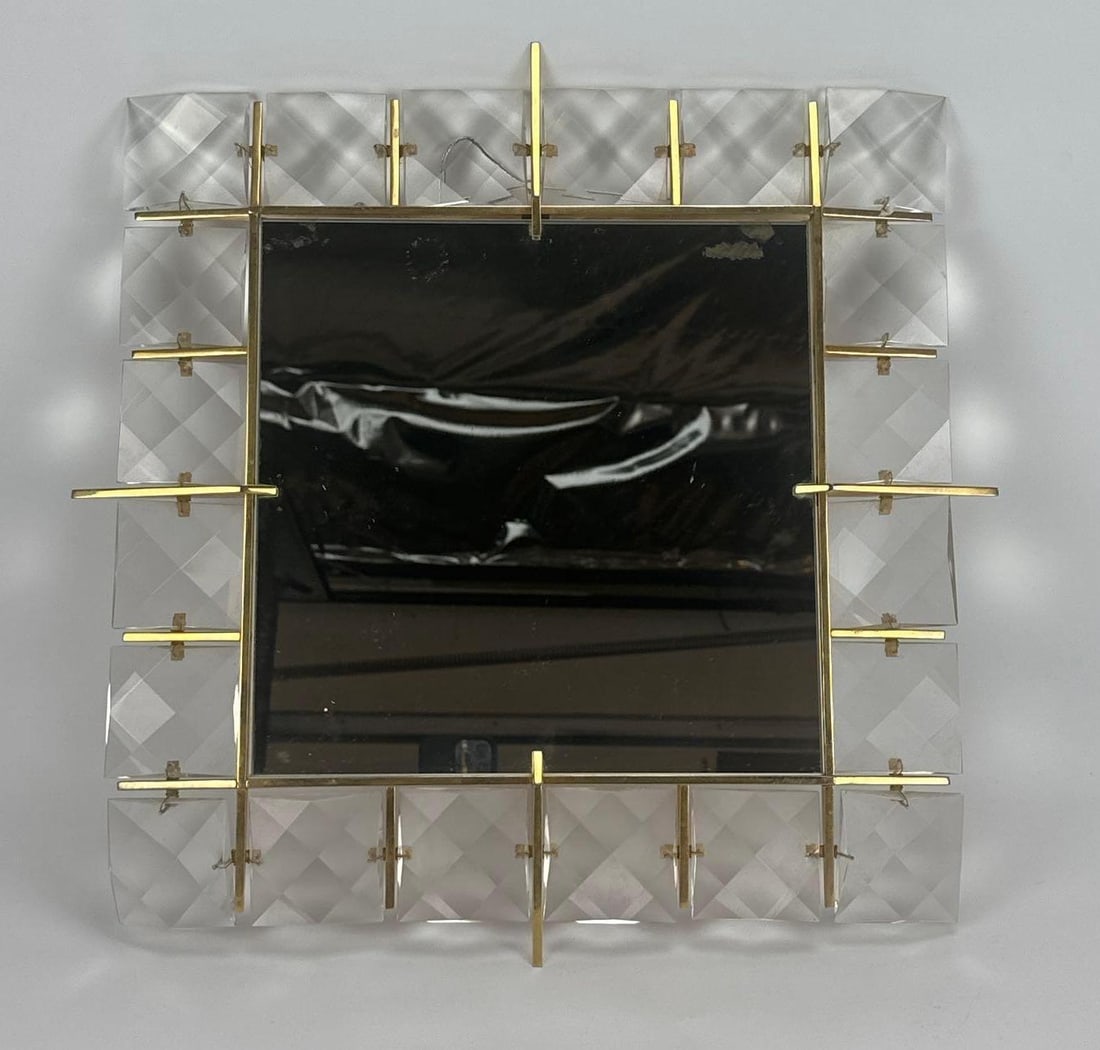 KINKELDEY GERMAN BRASS AND FACETED CRYSTAL MIRROR: *Mid-century modern square wall mirror framed by iconic multi-faceted lead crystal glass blocks and polished brass Approximate Dimensions:18” x 18” Artist or Maker: Kinkeldy