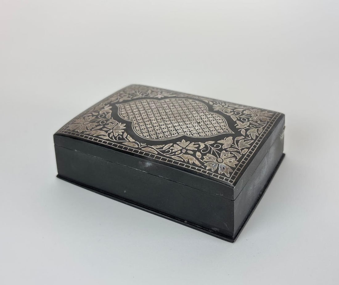 INDIAN BIDRIWARE SILVER INLAID ZINC ALLOY COVERED CURIO BOX: *Rectangular blackened metal Bidriware trinket box decorated with fine hand-inlaid silver floral vines, geometric lattice patterns, and a central cartouche design. Approximate Dimensions: 1.25" H 