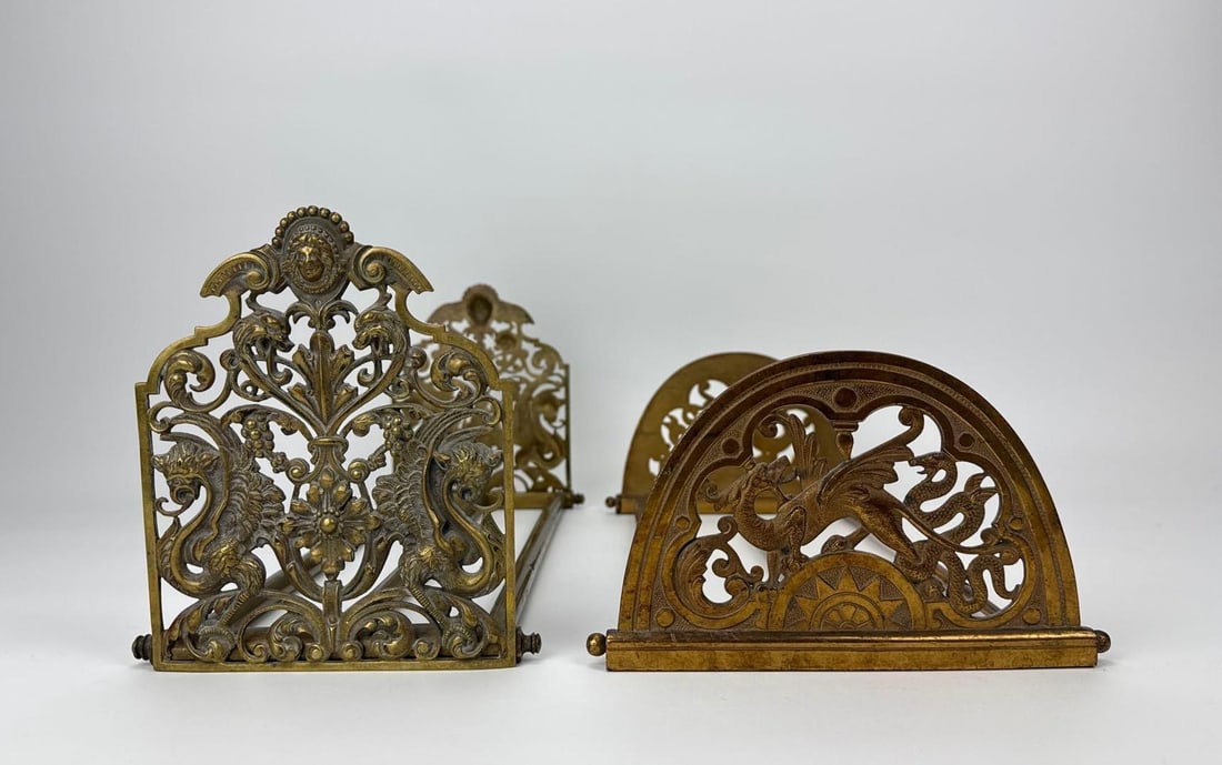 PAIR OF ANTIQUE EXPANDABLE DESK BOOK RACKS / BOOK SLIDES: *Pair of late 19th to early 20th century antique brass / copper? desktop sliding book racks. Approximate Dimensions: Larger 7” H X 17.5” W X 6” D Artist or Maker: Unknown