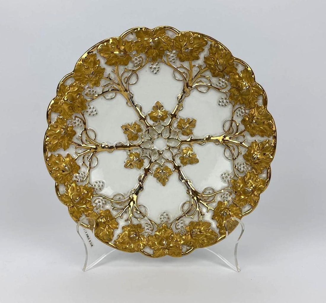 GERMAN MEISSEN HEAVILY GILT RELIEF GRAPEVINE PORCELAIN CABINET PLATE: *19th-century Meissen relief-molded porcelain cabinet plate adorned with heavy raised gilt grapevines, leaves, tendrils, and grapes surrounding a shallow center, bearing underglaze blue crossed swords
