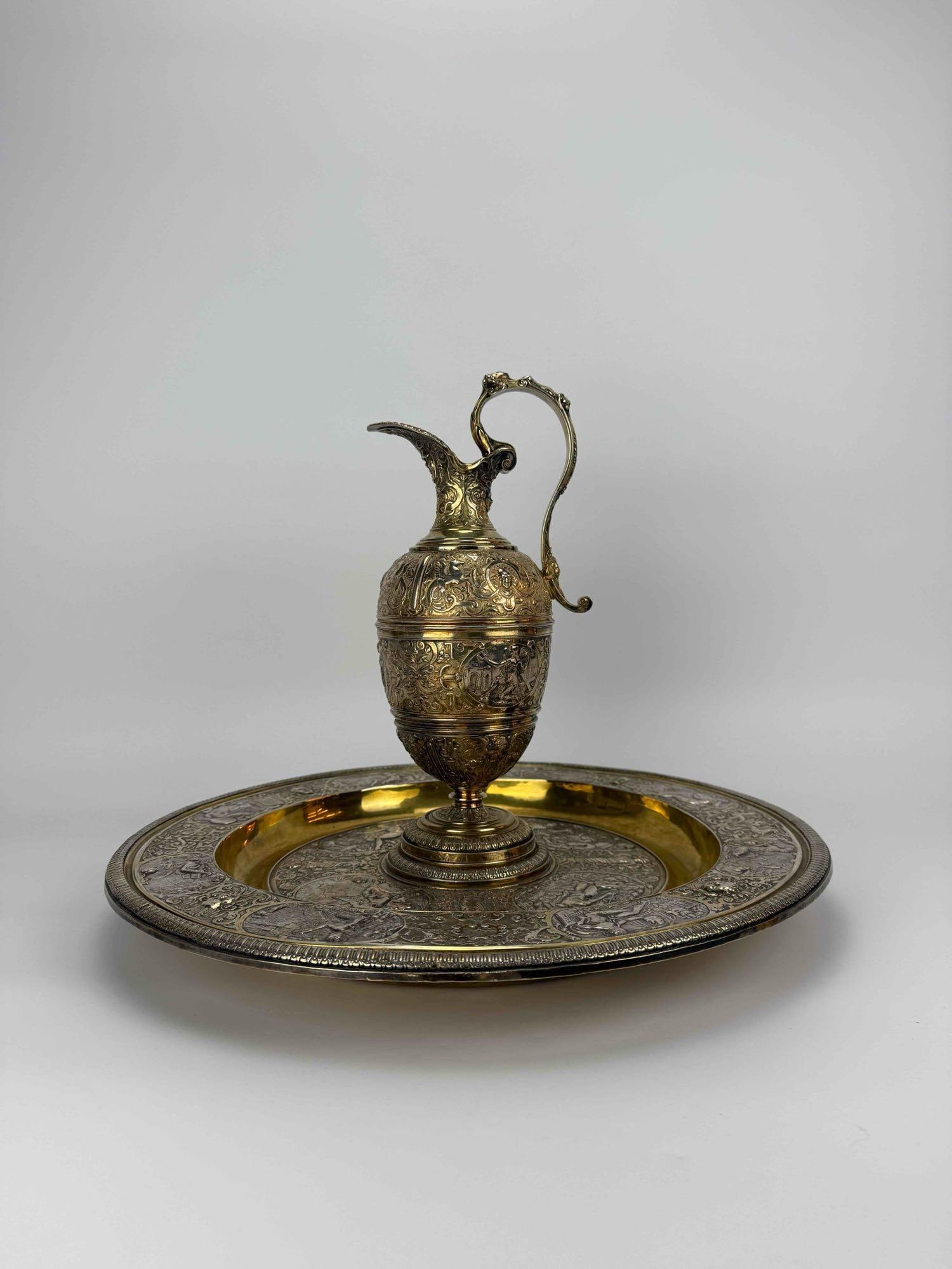 L. OUDRY 19TH CENTURY RENAISSANCE REVIVAL VERMEIL RELIEF EWER PITCHER AND BASIN: *Marked L. Oudry d[it]..." (Léopold Oudry). Elaborately chased and embossed Renaissance Revival silver gilt pitcher and basin adorned with relief classical figural medallions and scrolled handle.