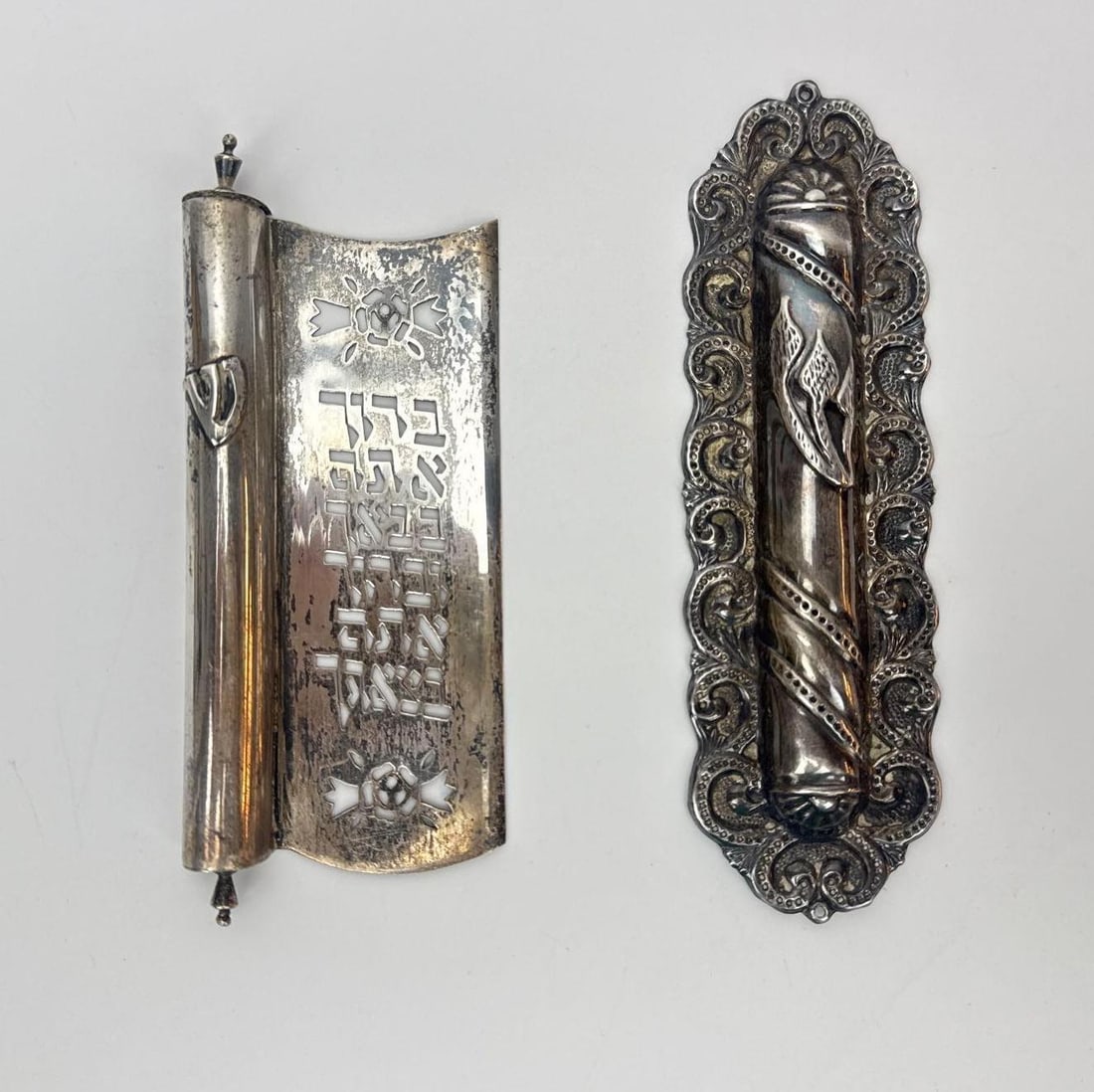 TWO STERLING SILVER MEZUZAH CASES WITH ORIGINAL PARCHMENT SCROLLS: Two silver mezuzah cases with original handwritten parchment scrolls Approximate Dimensions: taller 6.5" L x 2" W x 0.5" D; 3.130 ozt Artist or Maker: Silver (verify hallmark); Judaica Pro