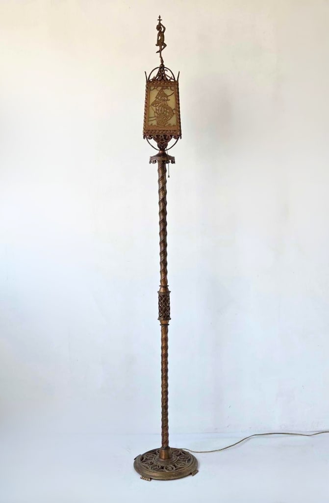 OSCAR BACH ATTR. BRONZE TORCHERE FLOOR LAMP: A tall, bronze torchere floor lamp with a twisted columnar standard, pierced lantern top with figural finial and reticulated base, rewired. Approximate Dimensions: 75" H x 12" Dia base Artist 
