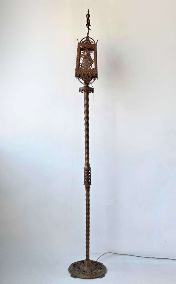 OSCAR BACH ATTR. BRONZE TORCHERE FLOOR LAMP: A tall, bronze torchere floor lamp with a twisted columnar standard, pierced lantern top with figural finial and reticulated base. GLASS PANELS MISSING, LAMP AS FOUND Approximate Dimensions: 75" H