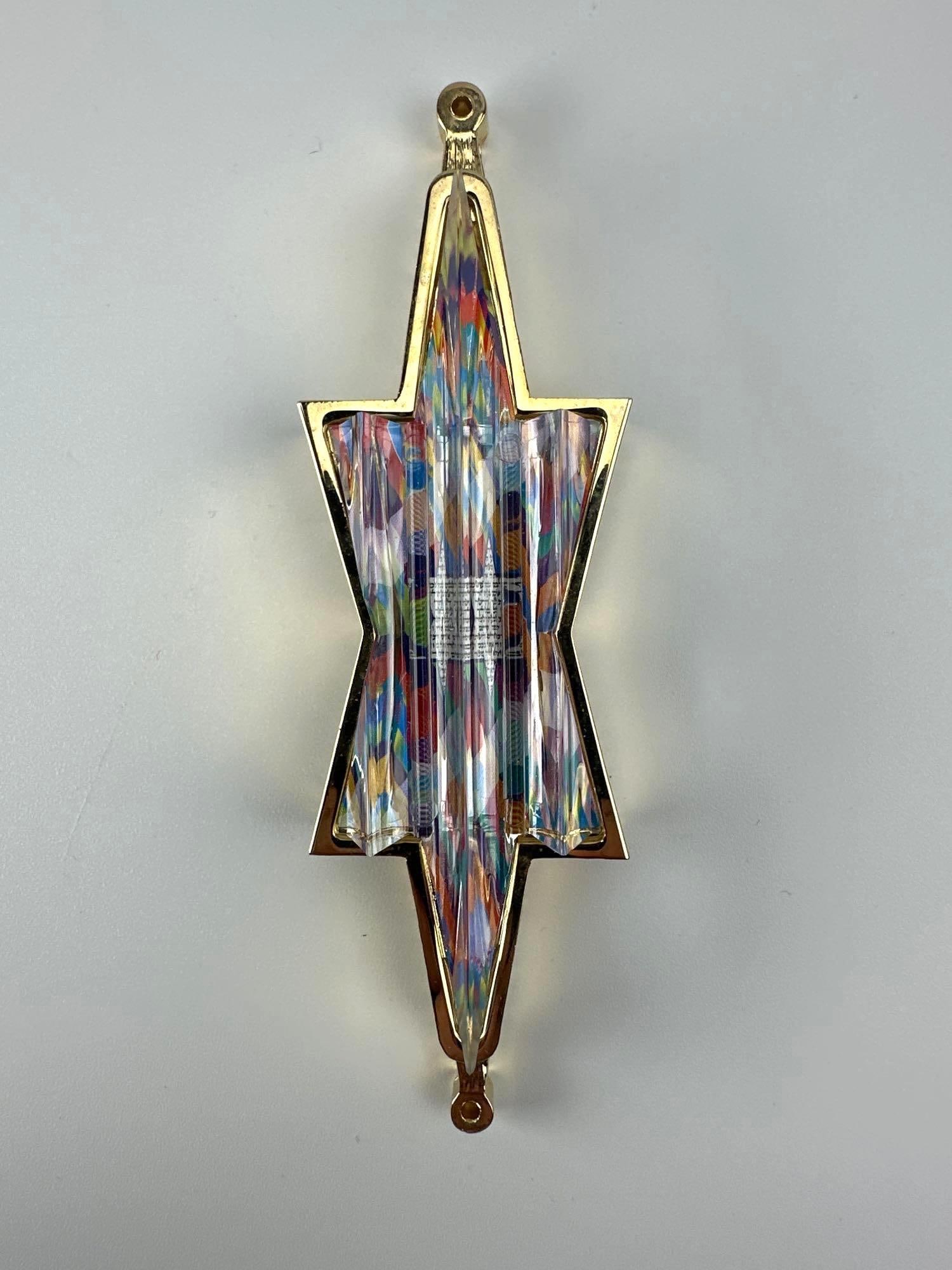 LIMITED EDITION MEZUZAH 309/950, ART GLASS AND GILT STAR OF DAVID: Limited edition gilt metal and polychrome art glass mezuzah in the form of an elongated Star of David, Hebrew scroll behind the glass, in its original fitted presentation box Approximate Dimensions: 5