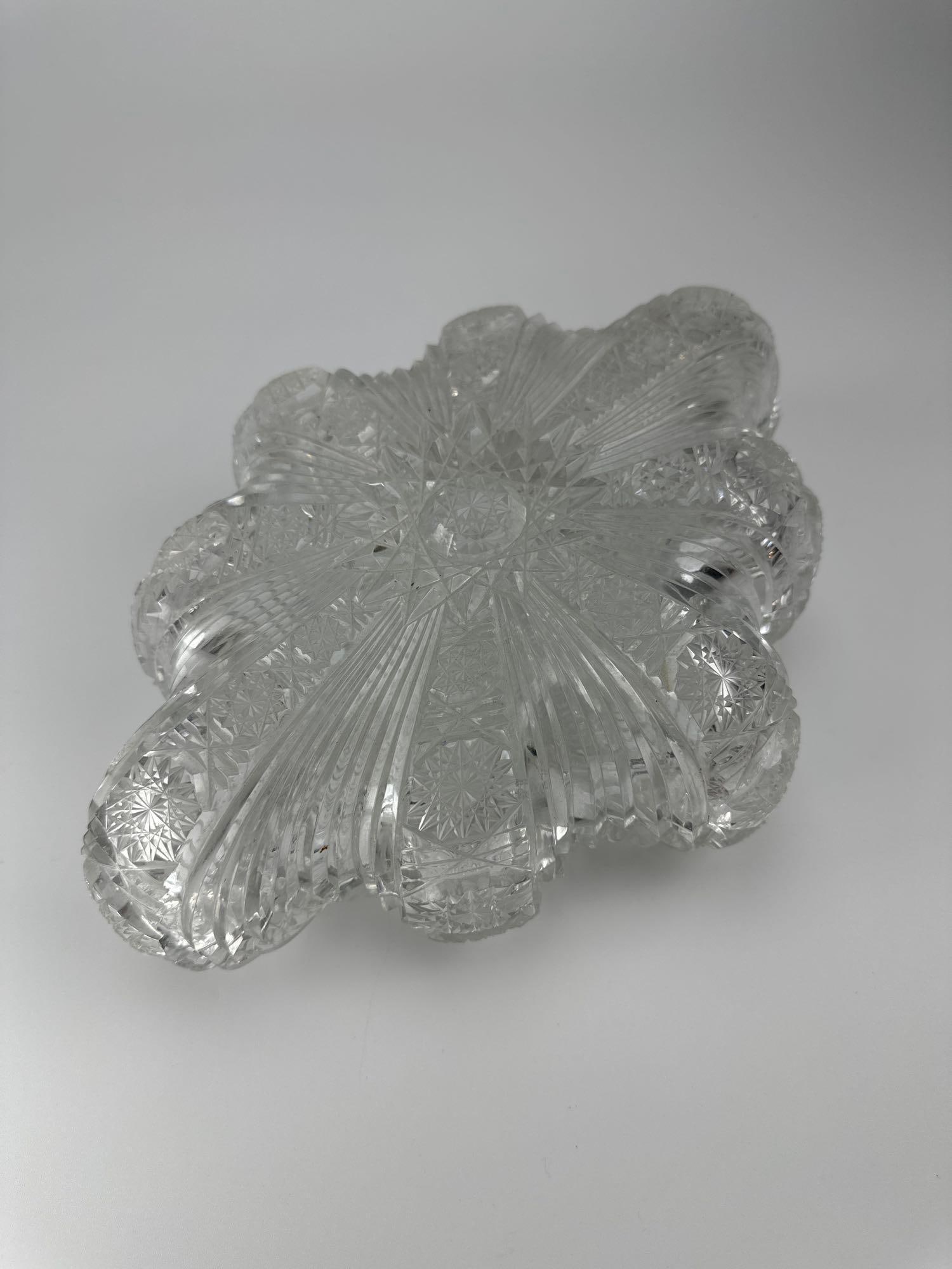 AMERICAN BRILLIANT PERIOD CUT GLASS LIDDED STAR DISH, HOBSTAR: American Brilliant cut glass relish dish, hobstar and fan cutting with cane-cut reserves and sawtooth rims Approximate Dimensions Largest Item: 4" H x 12" L x 9" W Artist or Maker: Unknown