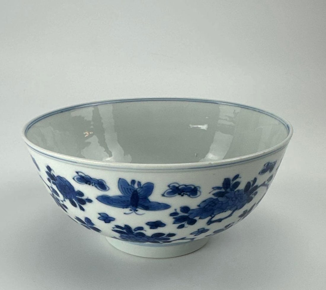 CHINESE BLUE AND WHITE PORCELAIN BOWL, KANGXI SIX CHARACTER MARK: Chinese blue and white porcelain bowl, underglaze blue floral sprays to the exterior and a roundel of flowers within a double circle to the interior well Approximate Dimensions: 3" H x 6" Dia.