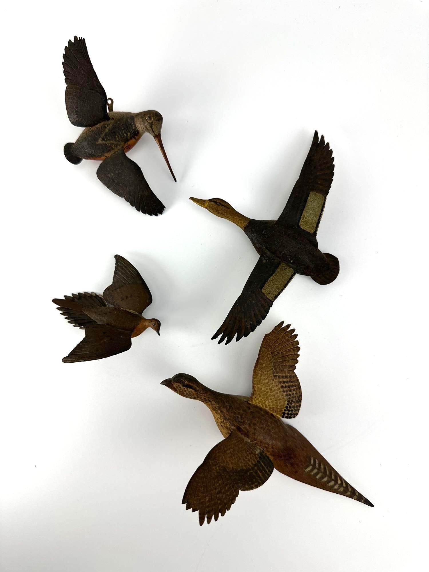 4 SIGNED CARVED WOOD FLYING BIRDS, WOODCOCK DUCK GROUSE FOLK ART: Four carved and painted wood flying bird wall plaques, pencil-signed on the wing undersides - minor losses and restoration. Approximate Dimensions: 5" H x 5" W each, approximately Artist or Ma
