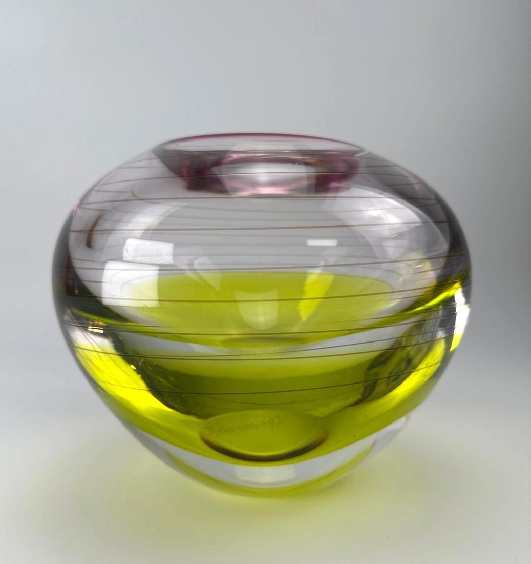 SIGNED STUDIO ART GLASS BOWL VASE, CLARE WALSH, CITRON AND RUBY: Signed studio art glass bowl vase of compressed spherical form, citron yellow green cased body with fine spiral cane threading and a ruby rim band Approximate Dimensions: 8" H x 9" Dia. Artist