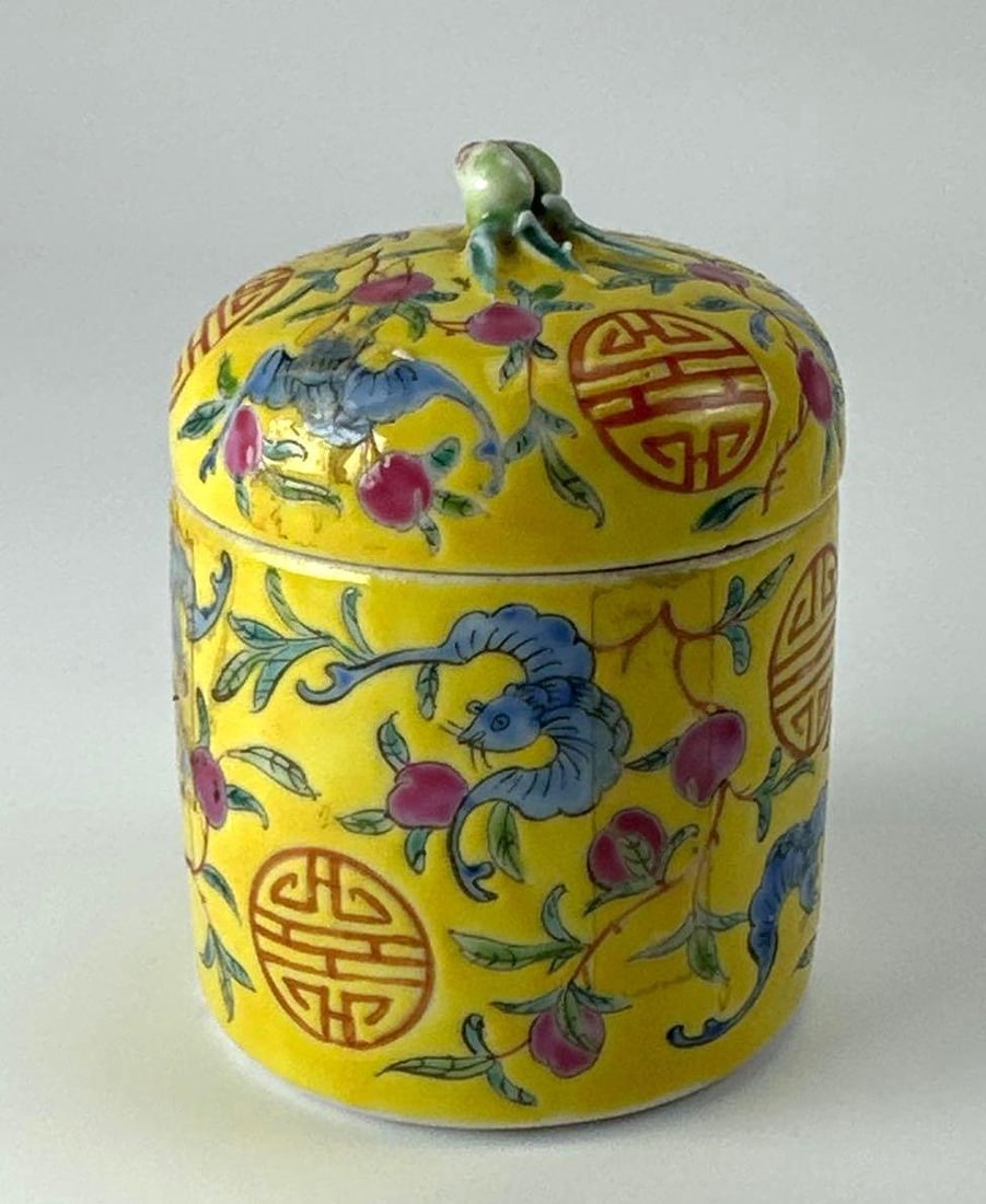CHINESE YELLOW GROUND FAMILLE ROSE SHOU COVERED JAR, GUANGXU MARK: Chinese yellow ground famille rose cylindrical covered jar. Approximate Dimensions: 4" H x 3" W x 3" D Artist or Maker: Unknown Provenance: From a New York Collector Notes: Although care i