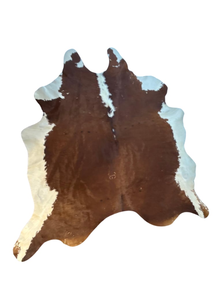 NATURAL BROWN AND WHITE COWHIDE RUG ARGENTINE 8' x 7': Natural brown and white cowhide area rug Approximate Dimensions: 94” x 88” Artist or Maker: Unknown Provenance: From a New York Collector Notes: Although care is taken to photograph and de